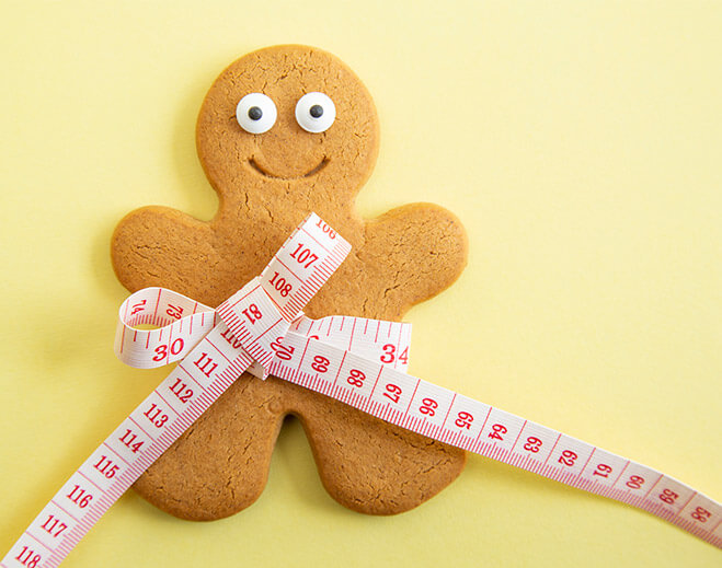 gingerbread man with measuring tape around his waist